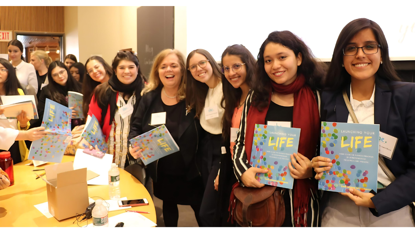 Erin Moran McCormick keynote at Harvard University with students holding her book